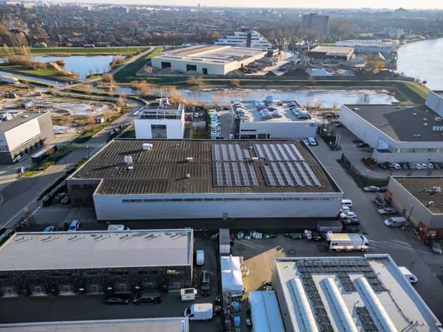 Bedrijfspanden van bovenaf met zonnepanelen op de daken